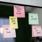 Colorful sticky notes with motivational messages on a mirror reflecting positivity.